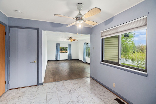92 Brookfield Dr, Oxford, MI 48371 - spare room featuring marble finish floors, a smoke detector, a ceiling fan, and baseboards