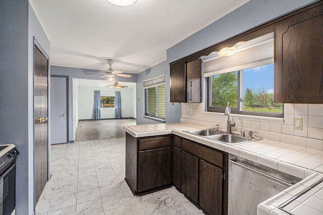 92 Brookfield Dr, Oxford, MI 48371 - kitchen featuring a sink, dark brown cabinetry, backsplash, and light marble finish floors