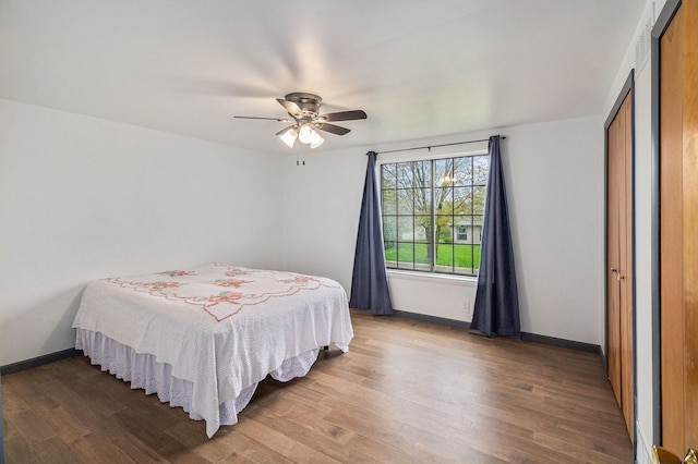 92 Brookfield Dr, Oxford, MI 48371 - bedroom with wood finished floors, baseboards, and ceiling fan
