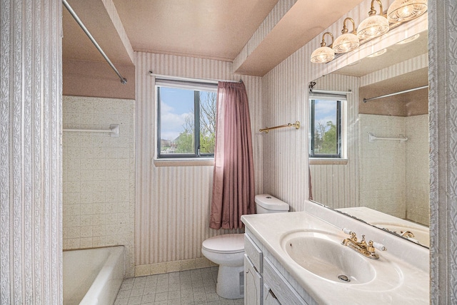 92 Brookfield Dr, Oxford, MI 48371 - full bathroom with healthy amount of natural light, toilet, wallpapered walls, vanity, and baseboards