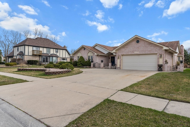tudor-style house featuring brick siding, an attached garage, a front yard, and concrete driveway