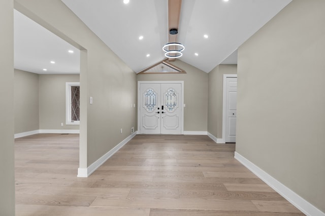 entryway featuring lofted ceiling with beams, baseboards, a notable chandelier, and light wood-type flooring