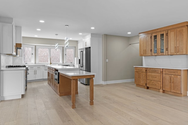 kitchen featuring decorative backsplash, recessed lighting, appliances with stainless steel finishes, and light wood-style flooring