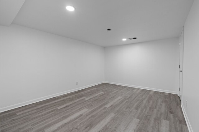 unfurnished room with visible vents, baseboards, wood finished floors, and recessed lighting