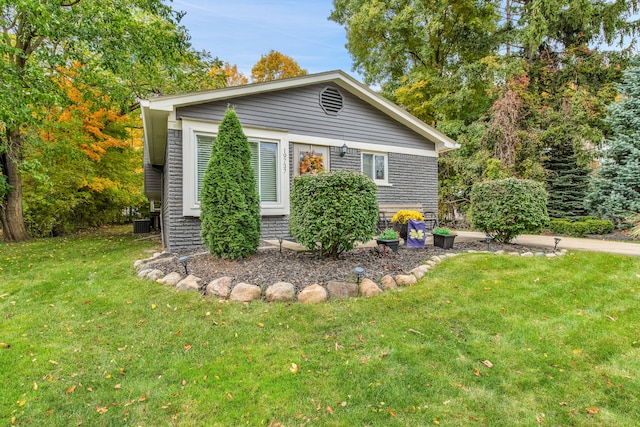 19737 Clement Rd, Northville, MI 48167 - view of front of house with a front yard and central AC