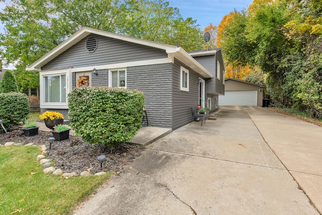 19737 Clement Rd, Northville, MI 48167 - view of front of property with a garage and an outbuilding