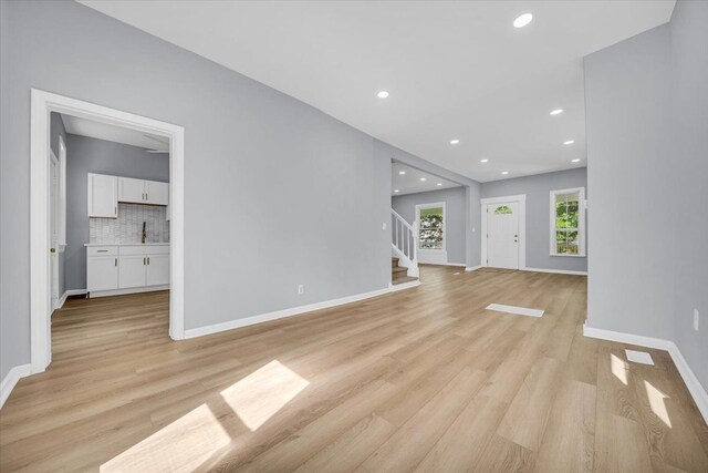 408 Mount Vernon St, Detroit, MI 48202 - unfurnished living room featuring light wood-type flooring, a sink, recessed lighting, and stairway