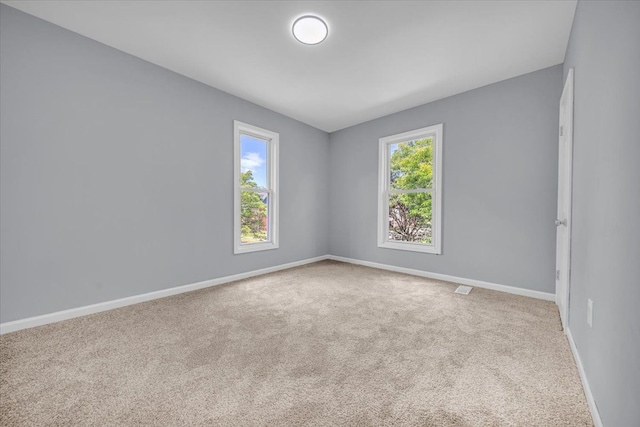 408 Mount Vernon St, Detroit, MI 48202 - carpeted empty room featuring baseboards, a healthy amount of sunlight, and visible vents