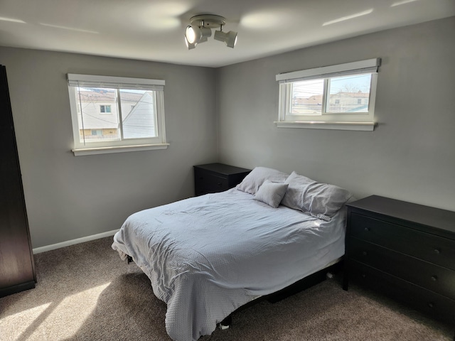 bedroom featuring baseboards and carpet floors