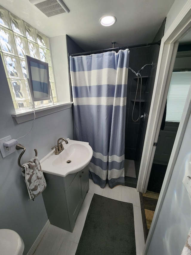 full bathroom with tile patterned floors, vanity, visible vents, and a shower with shower curtain