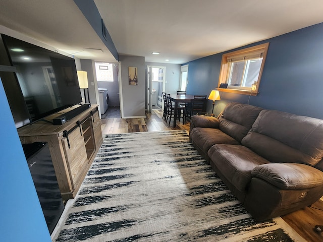 living area featuring recessed lighting, wood finished floors, and baseboards