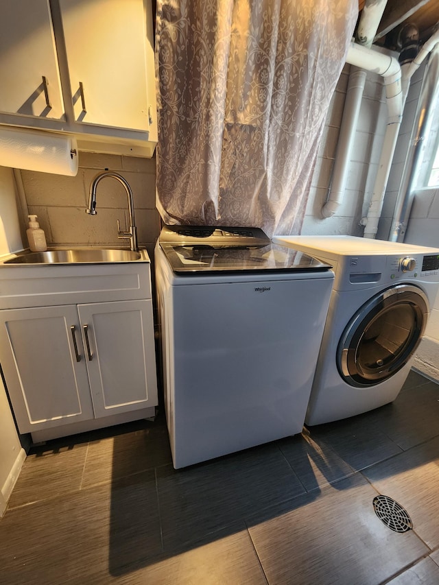 laundry area with a sink, washer and clothes dryer, and cabinet space