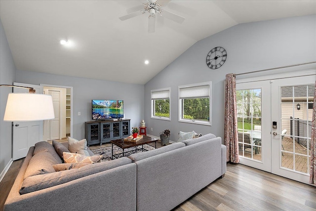 living room with ceiling fan, light wood-style floors, high vaulted ceiling, french doors, and recessed lighting