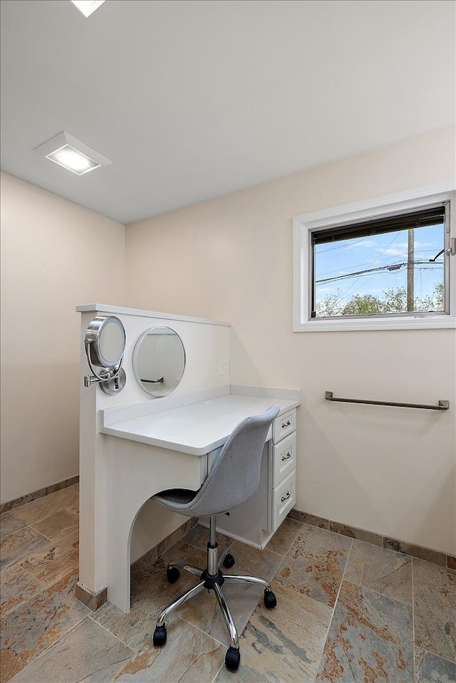office with stone tile floors and baseboards