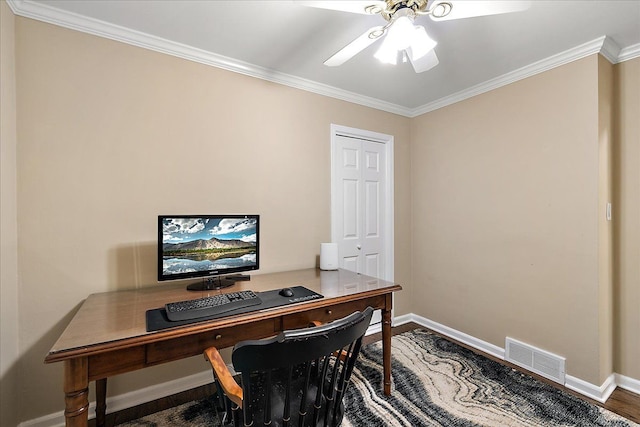 office space featuring visible vents, ornamental molding, wood finished floors, baseboards, and a ceiling fan
