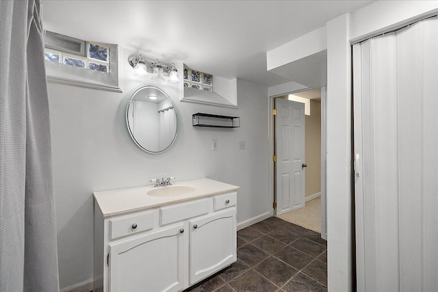bathroom featuring baseboards and vanity