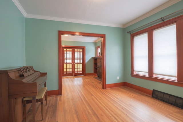 324 Albany St, Ferndale, MI 48220 - empty room featuring french doors, baseboards, light wood finished floors, and crown molding