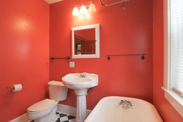 324 Albany St, Ferndale, MI 48220 - bathroom with a freestanding bath, toilet, and baseboards