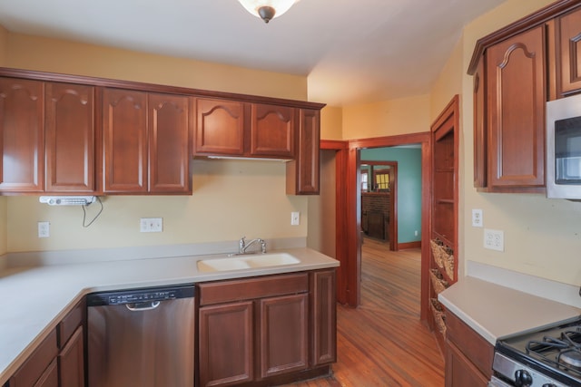 324 Albany St, Ferndale, MI 48220 - kitchen featuring appliances with stainless steel finishes, a sink, light countertops, and wood finished floors