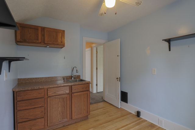 324 Albany St, Ferndale, MI 48220 - kitchen with a sink, brown cabinetry, light wood-style flooring, open shelves, and vaulted ceiling