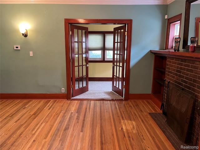 324 Albany St, Ferndale, MI 48220 - unfurnished living room with french doors, wood finished floors, baseboards, and ornamental molding