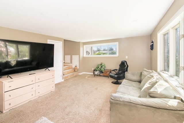 living area with baseboards and light carpet