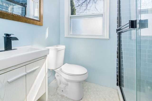 full bathroom with a stall shower, tile patterned floors, vanity, and toilet