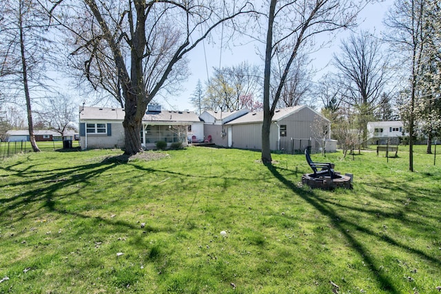 view of yard featuring fence and an outdoor fire pit