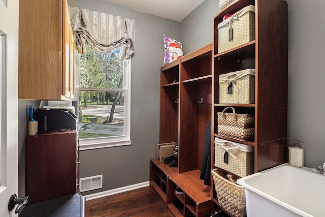 mudroom featuring a sink, baseboards, dark wood-style floors, and visible vents