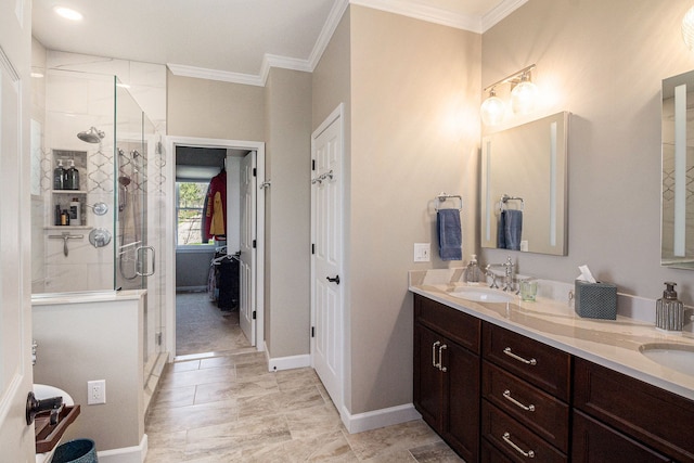 full bathroom with a sink, ornamental molding, a stall shower, and double vanity