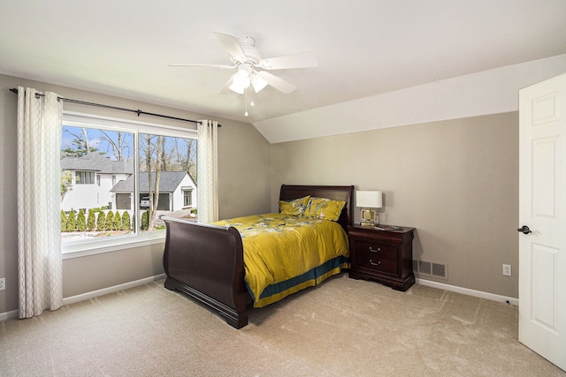 bedroom with visible vents, lofted ceiling, light carpet, baseboards, and a ceiling fan