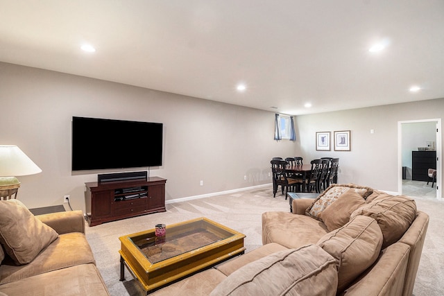 living room featuring baseboards, light carpet, and recessed lighting
