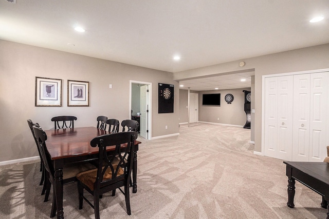 dining room with light carpet and recessed lighting