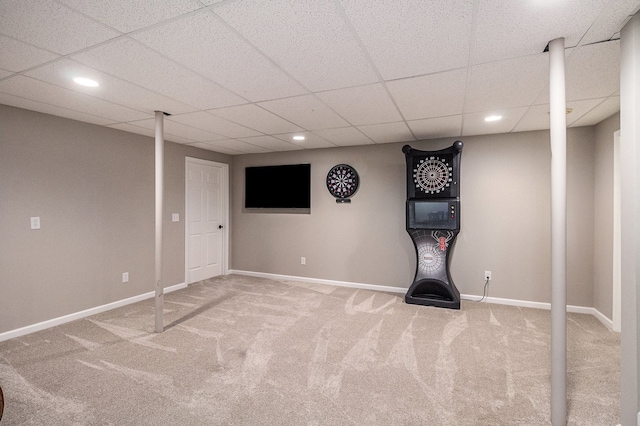finished below grade area with baseboards, a drop ceiling, carpet flooring, and recessed lighting