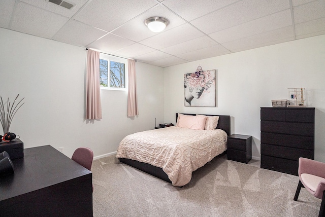 bedroom featuring carpet floors, baseboards, visible vents, and a paneled ceiling