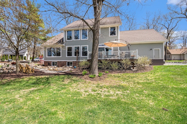 back of house with a lawn and a deck