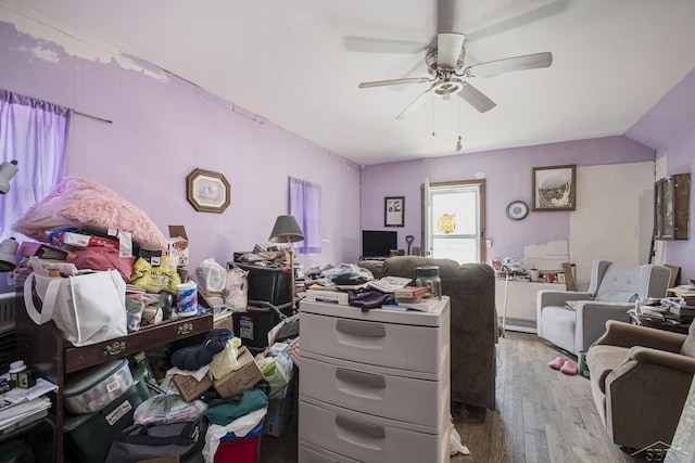 office with hardwood / wood-style floors, a baseboard heating unit, and ceiling fan