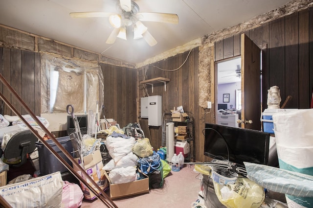 misc room with wooden walls and ceiling fan