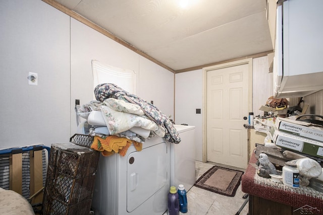 laundry room featuring washer / dryer and cabinet space