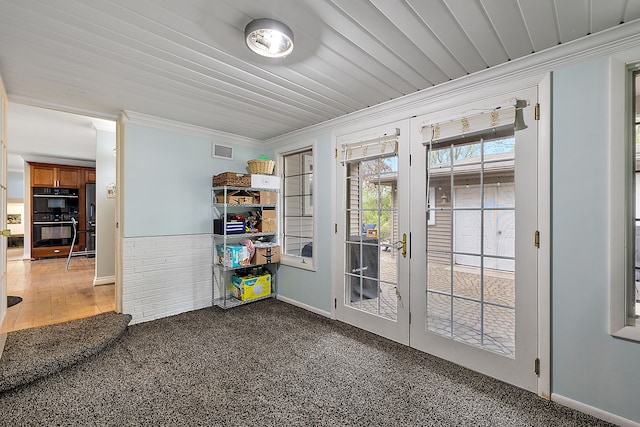 doorway to outside with visible vents, ornamental molding, carpet floors, baseboards, and french doors