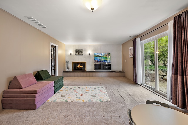 living room with carpet floors, a fireplace, and visible vents