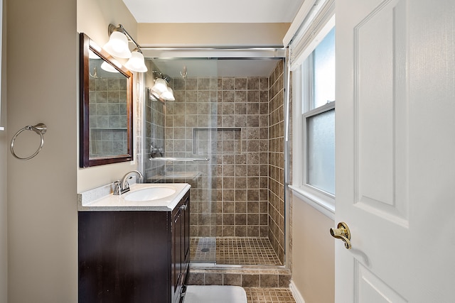 full bathroom featuring vanity, tile patterned floors, and a stall shower