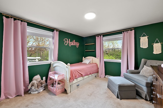 carpeted bedroom featuring multiple windows