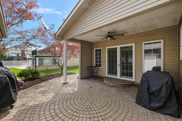 view of patio with fence, a ceiling fan, and area for grilling