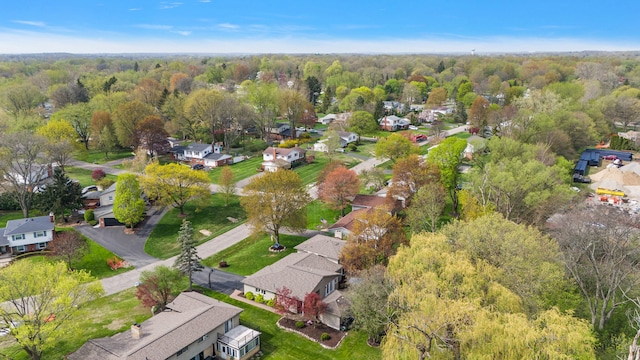 drone / aerial view featuring a view of trees and a residential view
