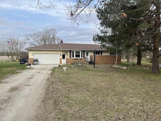 ranch-style house featuring brick siding, dirt driveway, an attached garage, and a front yard
