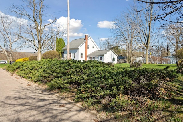 view of home's exterior featuring a chimney