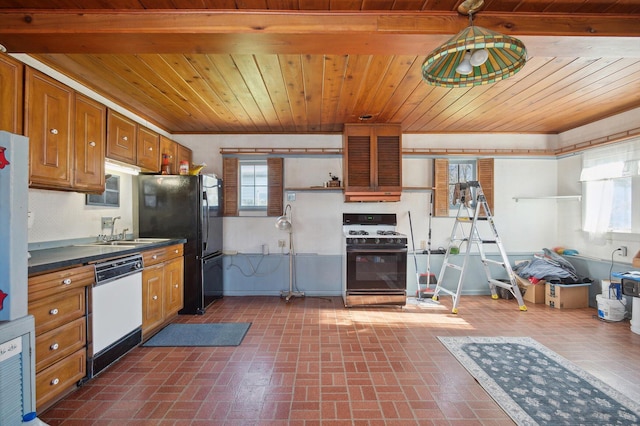kitchen featuring dark countertops, a sink, brick floor, dishwasher, and gas range oven