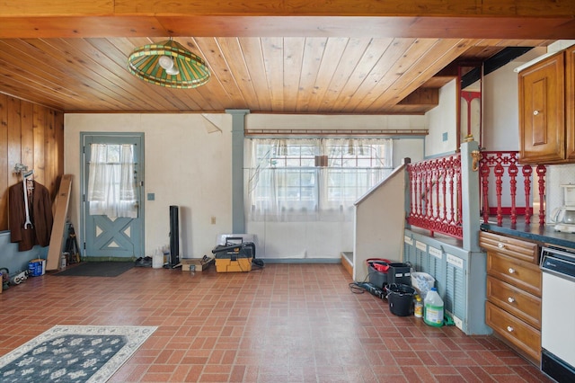 interior space featuring wood ceiling, wooden walls, and brick patterned floor