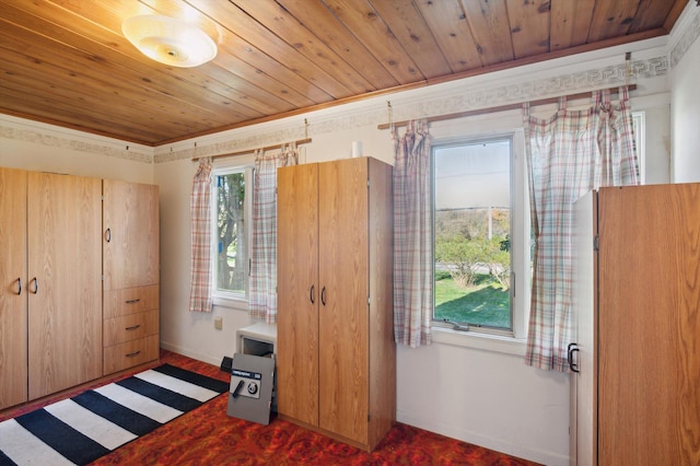 carpeted bedroom with wooden ceiling, baseboards, and ornamental molding